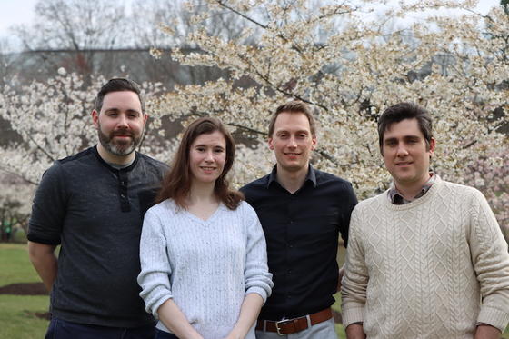 cherry blossom researchers pose by the trees